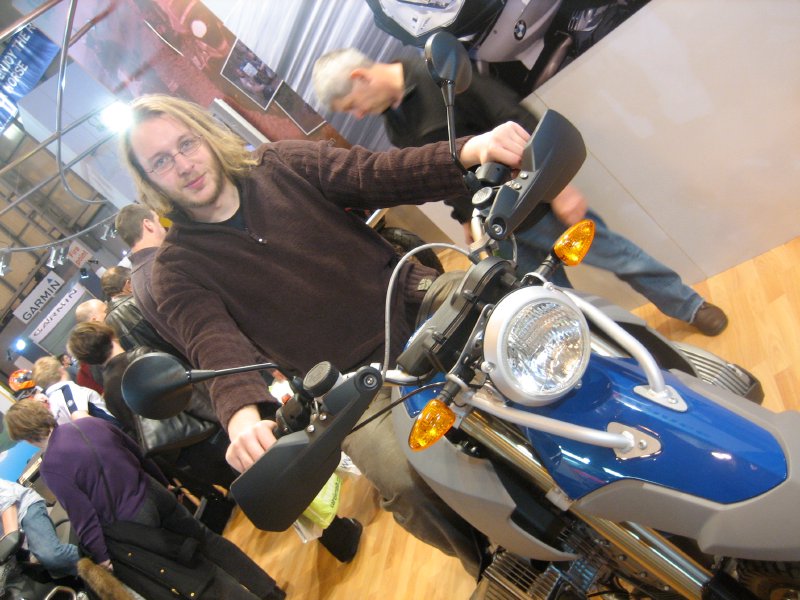 Me sat on top of a BMW HP2 off road bike inside a convention hall