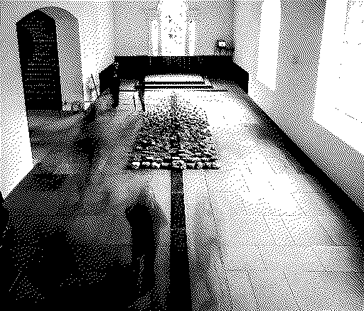 A 1-bit dithered image of a long exposure of people walking around some art at Yorkshire Sculpture Park.
