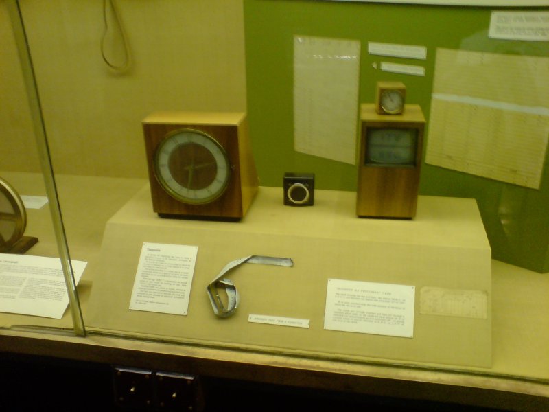 A picture of some old wooden covered electronic devices that look a bit like a clock or a small TV.