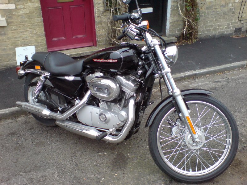 A classic Harley Davidson chopper parked on a residential street