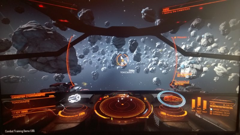 Scene from Elite:Dangerous looking over an asteroid field from the cockpit of a Sidewinder