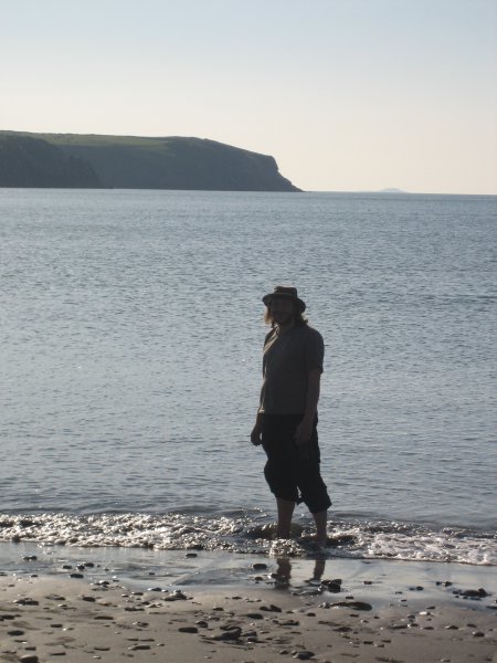 A photo of me paddling in the sea, mostly in my biker gear still.