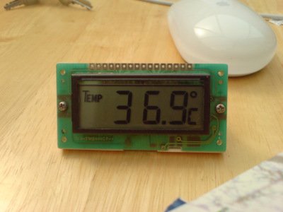 A photo of a kit-based digital temperature thing showing 36.9˚C