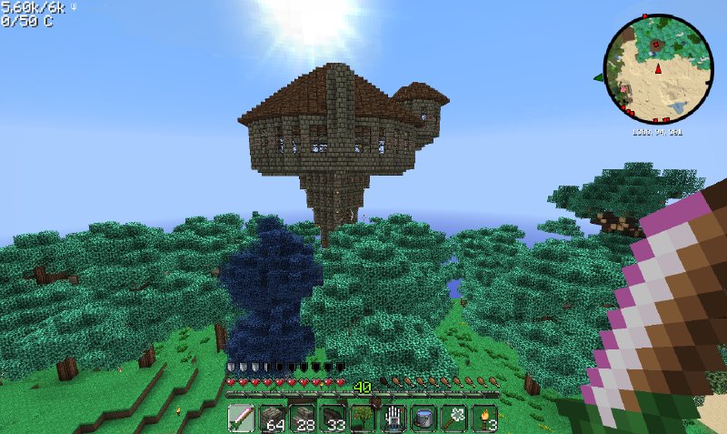 A minecraft screenshot showing a wizards tower, a sort of narrow spike with a round house on top, sticking out above the trees.