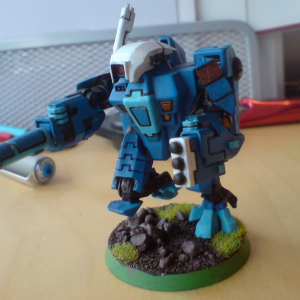 A close up of a Tau mech-robot painted minature from Warhammer 40K