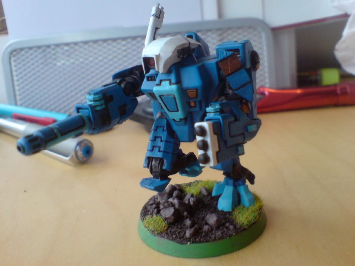 A close up of a Tau mech-robot painted minature from Warhammer 40K