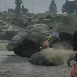 A screenshot of GTA V with a player upside down over a rock next to a crashed quadbike.