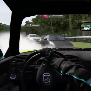 A screenshot of Forza Motorsport showing a first person view in a car looking the wrong way down the track at oncoming vehicles.