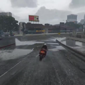 A screenshot of GTA V showing someone on a motorbike approaching a busy city junction.