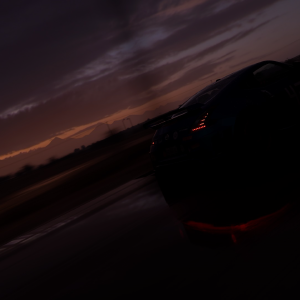 An in-game photo from Forza Horizon 5, showing a silhouetted Nissan 370z with the dusk sun setting over some hills in the distance.