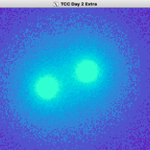 A video of a window showing two glowing blobs moving to and from each other, with a field effect in purple glowing around them.
