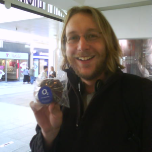 A photo of me holding a cup-care with an O2 logo on top.