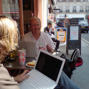 Quentin and me sat on a tiny table outside a cafe on a narrow street in London, both with our laptops out.